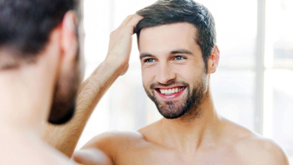 Happy man showcasing results of his Antalya hair transplant at Wings Health